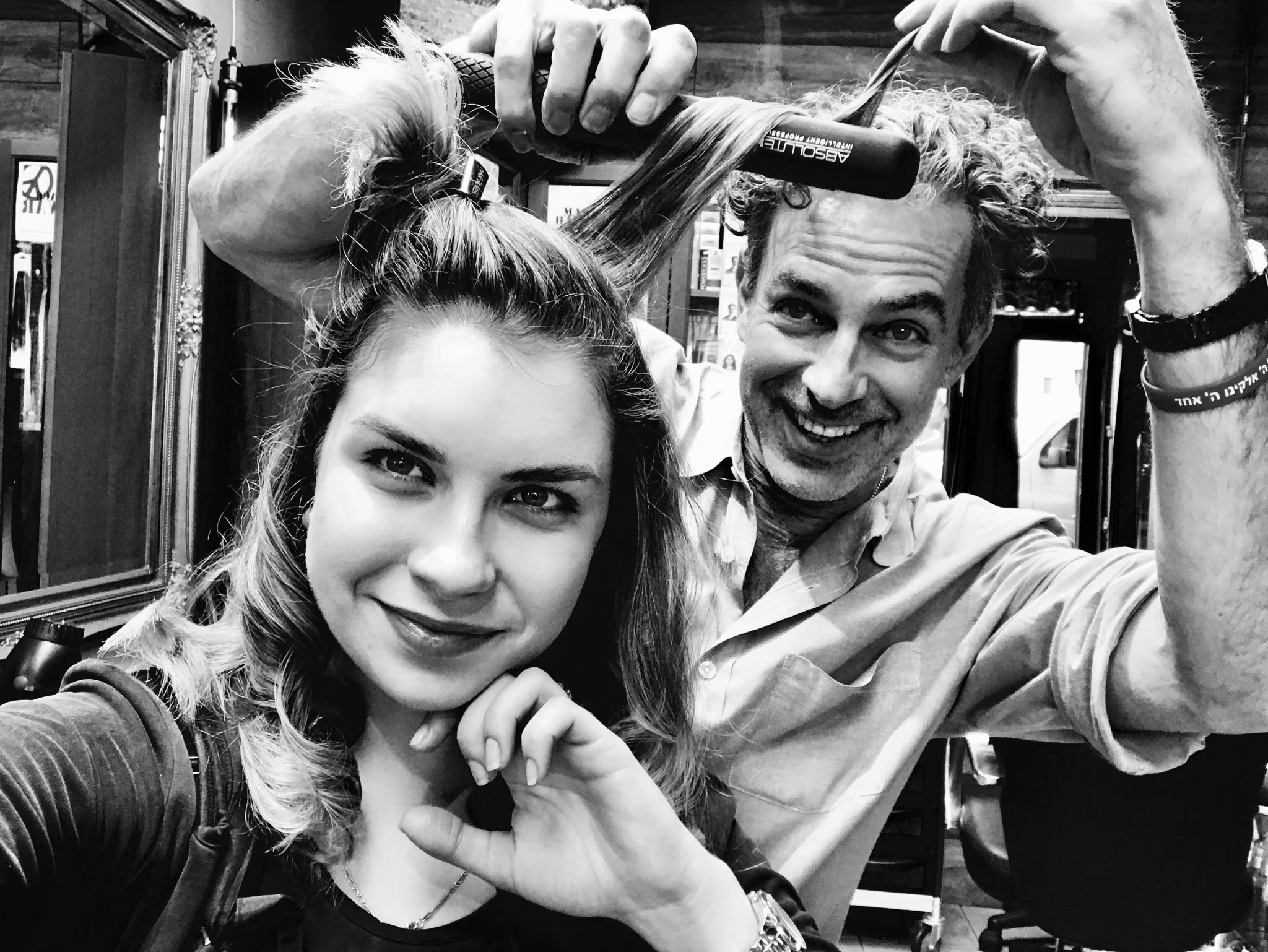 Matthew playfully lifting a client's hair