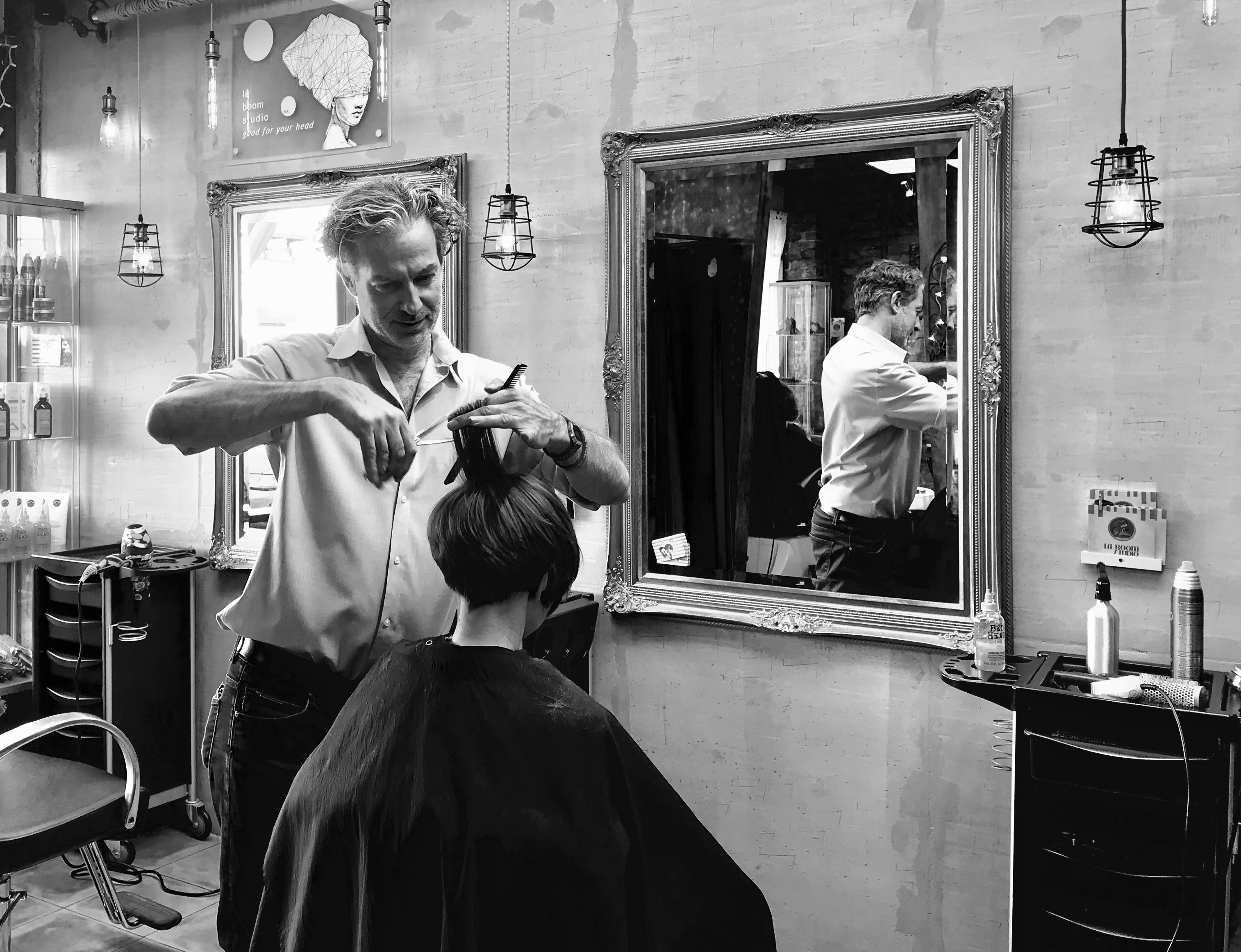 Matthew cutting hair at the gilded mirror