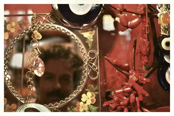 Mirror with coral decorations and Matthew's reflection